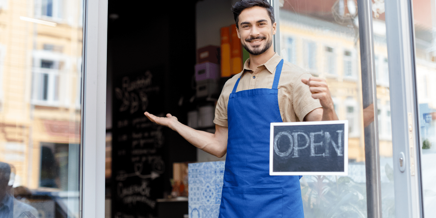 Small business owner with open sign. Ownership Concept