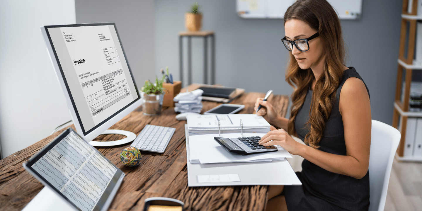 Woman calculating invoice at workplace. Tax Break Concept